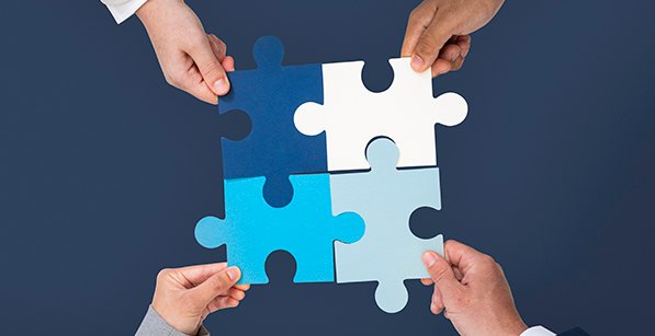 Hands holding puzzle business problem solving concept