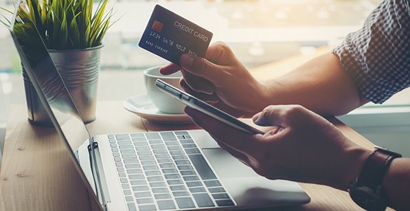 Man holding credit card payment shopping online on smart phone