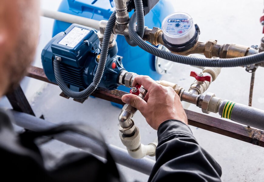 Technician checking water system nodes. Modern Industrial background.