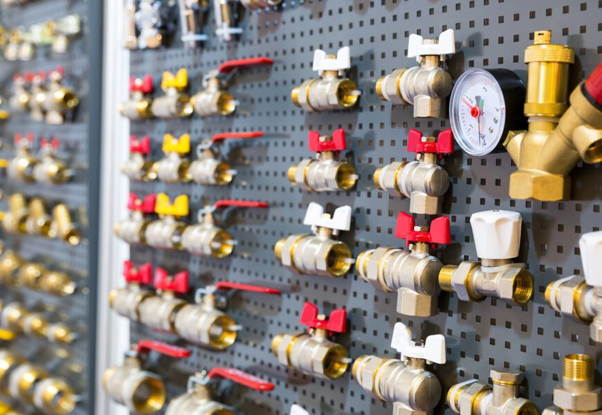 Different valves and other plumbing equipment on the wall